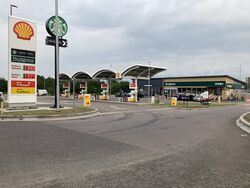 The logos for Shell and Starbucks, in front of a forecourt with a very small canopy.