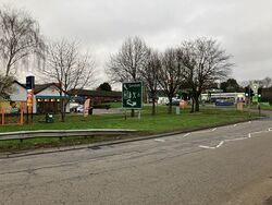 A sign saying Services, viewed from across the road.