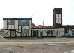 Derelict restaurant building with a sign saying Hot & cold meals, All day breakfast