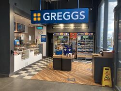 Greggs logo above the entrance to a store.