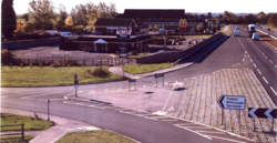 The newly completed left turn on the A64 westbound, pictured from the flyover, showing the unused restaurant building in the foreground.