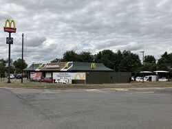 A McDonald's restaurant, viewed across a road.
