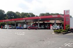 A large petrol station with signs saying Total.