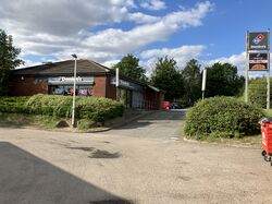 Domino's building at the back of a car park.