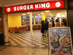 Entrance to a Burger King restaurant with a tiled floor.
