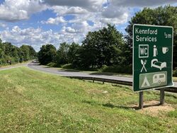 Green road sign saying Kennford services.