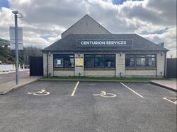 Restaurant building with a sign saying Centurion services.