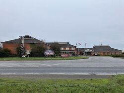 Two-storey hotel building, pictured from across the road.