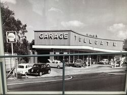 Old garage building with signs saying Shell and Tollgate.