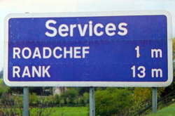 A road sign saying: Services, Roadchef 1m, Rank 13m.