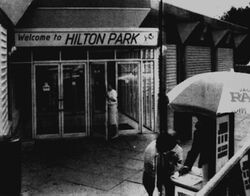 "Welcome to Hilton Park", written across the door to the building, with a gongman logo.