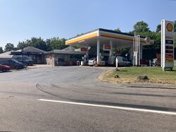 A Shell forecourt, with a SPAR branded shop and a Subaru car dealership attached.