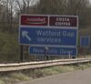 Sign saying 'Roadchef - Watford Gap services' on left.