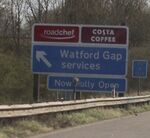 Sign saying 'Roadchef - Watford Gap services' on left.