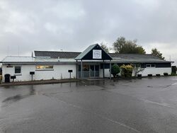 Flat-roofed building with a sign saying Skiach Services RESTAURANT.