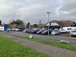 Cars parked in front of a building.