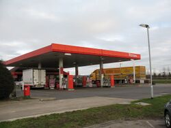 A petrol station with a red canopy.