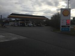 A petrol station, branded Shell, with a brick canopy.