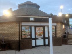 Brick building with a pagoda roof and an advert for Burger King on the wall.