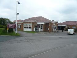 Single-storey brick building with a sign saying Services & Hotel.
