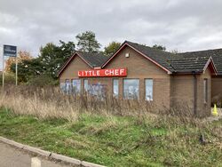 A Little Chef restaurant building with boarded up windows.