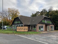 A brick building with Bed & Mattress written across it.
