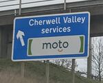 Sign saying 'Cherwell Valley services - Moto' on left.