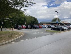 A car park, with a McDonald's building behind it.