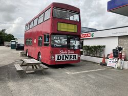 Red double decker bus which says Eat On The Bus.