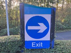 Turn right sign with a blue swerve on top.