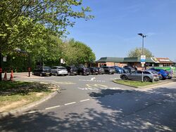 A car park, with a McDonald's building behind it.