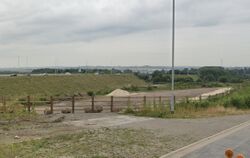 Concrete base in the middle of cleared land.