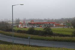 A distant view of a red filling station.