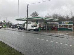 A BP forecourt next to a road, with a Costcutter and Subway shop.