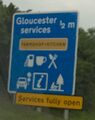 Sign saying 'Gloucester services, farmshop & kitchen'.