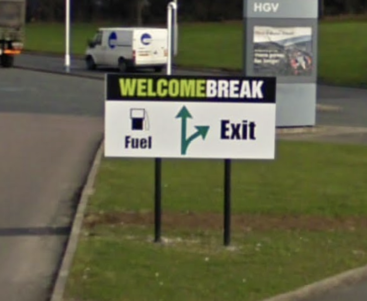 File:Welcome Break arrowed map sign.png
