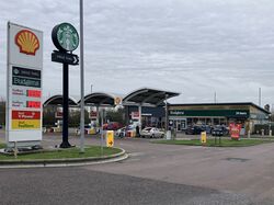 The logos for Shell and Starbucks, in front of a forecourt with a very small canopy.