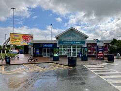 The front of the building, with a sign saying Welcome to Moto.