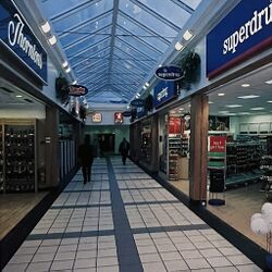 A corridor with Thorntons and Tandy Express on the left, and Superdrug on the right.