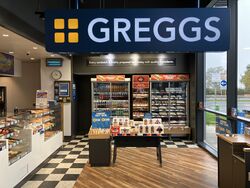 Greggs logo above the entrance to a store.