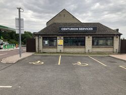 Restaurant building with a sign saying Centurion services.