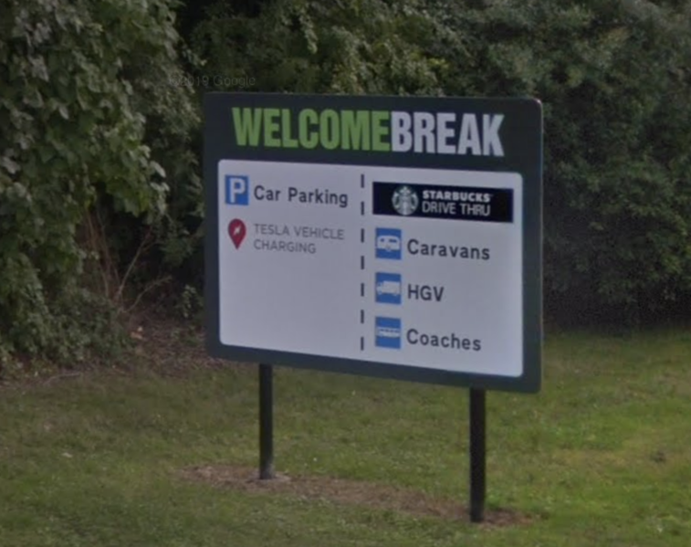File:Welcome Break lane sign.png