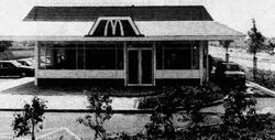 Black and white image of a McDonald's drive thru.