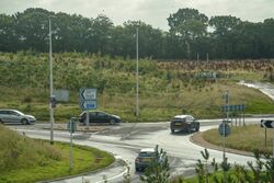 A roundabout with fields behind it.
